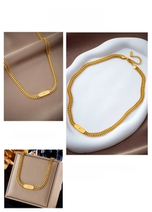Detail of gold-plated titanium steel necklace featuring a square tag with sparkling zircon