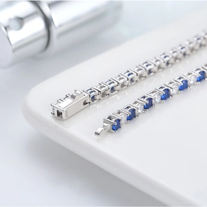 Classic silver S925 tennis bracelet featuring round blue and white cubic zirconia gems