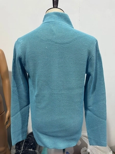 Detailed view of sky blue waffle knit texture and stitching on long sleeve cardigan