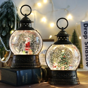 Vintage bronze Christmas lantern music box with Santa and tree inside, glowing snow globe