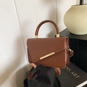 Minimalist brown lychee pattern leather handbag with metal buckles and shoulder strap