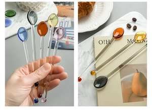 Detail of colorful long handle glass stirring spoons in various translucent pastel colors