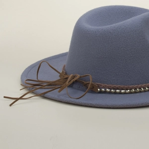Close-up of wool fedora hat with brown braided leather band and silver metal rivets