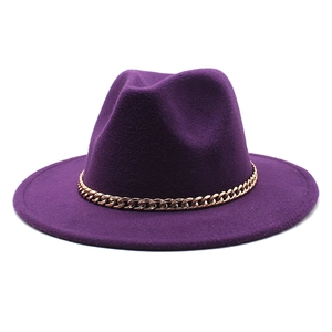 Detail of deep purple wool fedora hat featuring a decorative gold metal chain link band