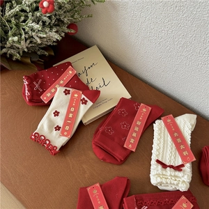 Collection of red and white cotton crew socks with festive embroidery and bow details