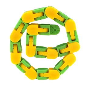 Detailed close-up of yellow and green wacky tracks fidget toy in a coiled configuration
