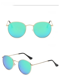 Detail view of round gold frame polarized sunglasses with green mirrored lenses