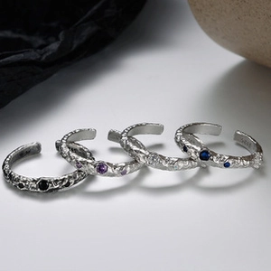 Detail showing S925 sterling silver rings with irregular texture and colorful gemstones