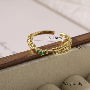 Detail view of gold wheat texture ring with three green zircon stones and measurements