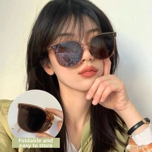 Detail view of foldable brown sunglasses showing easy storage design and compact frame