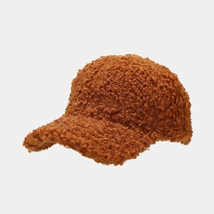Close-up of caramel teddy fleece baseball cap showing thick plush texture and seams