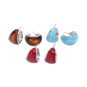 Set of three resin C-shaped hoop earrings in amber, light blue, and red with silver studs
