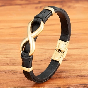 Men's black leather bracelet featuring a golden infinity charm and stainless steel clasp
