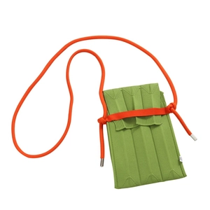 Handmade knitted mini crossbody phone bag with green pleated texture and orange shoulder strap
