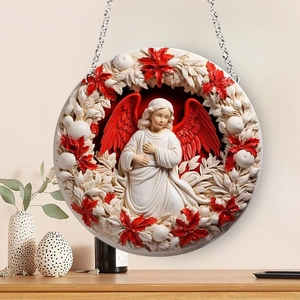 Detail of a Christmas angel ornament with red wings and relief floral patterns