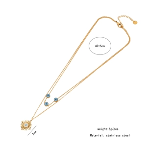 Detail view of double-layer stainless steel necklace with evil eye and star pendant