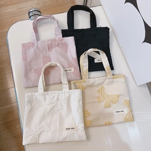 Mini floral jacquard bow handbags in pink, black, white, and beige with brand labels