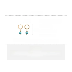 Detail view of gold turquoise drop earrings with dimensions of 3.5cm by 1.5cm