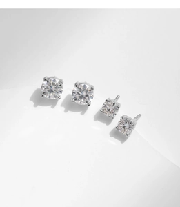 Close-up of classic 1-carat round moissanite earrings with 4-prong silver settings