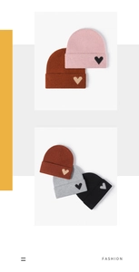Detailed knit texture of a warm winter beanie featuring a heart jacquard pattern