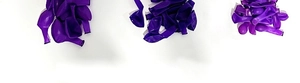 Top view of multiple stacks of round purple latex balloons for party decoration