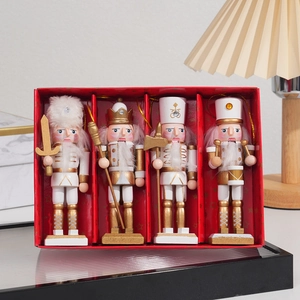 Detail of four glittery wooden nutcracker soldiers in a festive red gift box set