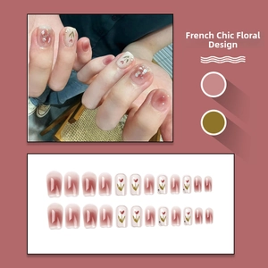 Macro view of French style press-on nails with pink gradient and tulip floral accents