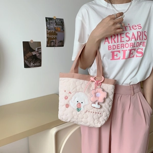 Detail of pink quilted handbag with Bichon Frise embroidery and 3D floral charm