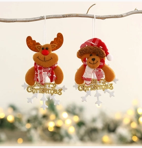 Detail of plush Christmas elk and bear tree ornaments with gold Merry Christmas lettering