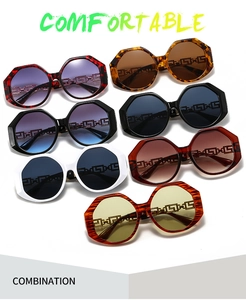 Detailed display of oversized geometric sunglasses in seven assorted color combinations