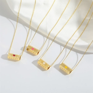 Golden Lucky cylinder pendant necklaces with colorful enamel heart charms on white silk
