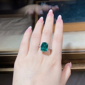 Close-up of model wearing an S925 sterling silver ring with a square emerald gemstone
