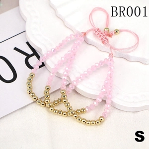 Three-piece stackable beaded bracelets with pink crystals and gold beads on adjustable cords