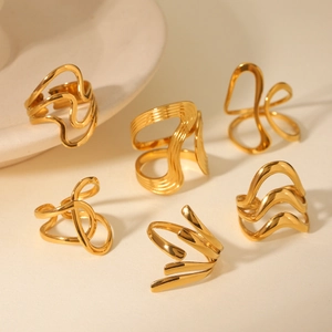 Detailed close-up of 18K gold plated hollow geometric rings with minimalist aesthetic