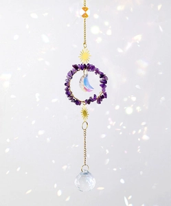 Macro detail of natural purple crystal moon and sun prism hanging garden suncatcher