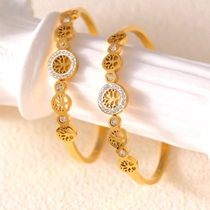 Gold plated titanium steel bangle featuring hollow Tree of Life design with sparkling zircons