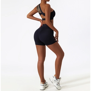Detail of black sports set featuring back cross-strap sports bra and high-waist biker shorts