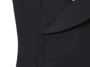 Détail du tissu tissé noir montrant des coutures de qualité et une texture fine