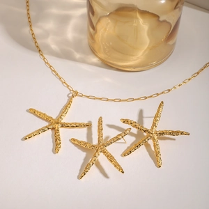 Golden stainless steel starfish necklace and earrings set with textured finish for beach