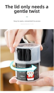 Detail of 100 double-headed black cotton swabs in a rotating transparent cylinder box