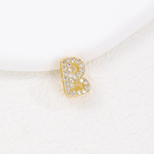 Detailed view of a gold letter B pendant featuring sparkling cubic zirconia stones