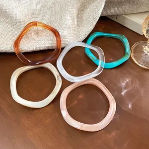 French vintage amber resin bangles set in five colors with irregular wavy patterns