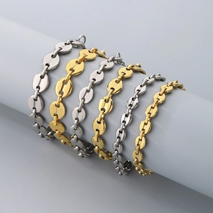 Set of six gold and silver stainless steel coffee bean link chain bracelets on display