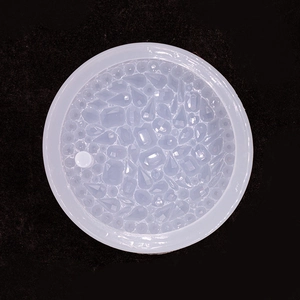 Close-up of translucent round silicone mold with various diamond and gemstone shapes