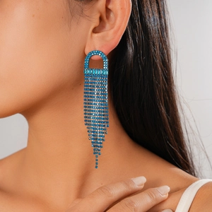 Detailed close-up of blue rhinestone long tassel earrings with sparkling U-shaped design