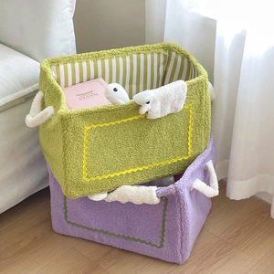 Detail showing plush rectangular storage baskets with soft fleece texture and handles