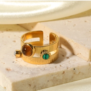 Vue macro d'une bague double couche plaquée or avec œil de tigre et malachite