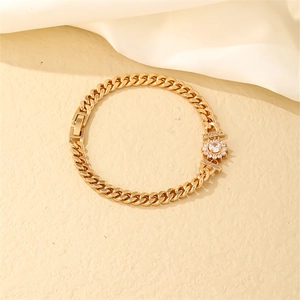 Detail of gold Cuban chain bracelet featuring a sunflower pendant with zircon stones