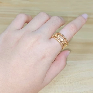French vintage 18K gold plated hollow leaf adjustable ring worn on hand over wooden table