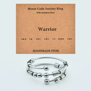 Detailed macro view of 316L stainless steel Morse code fidget ring with movable beads